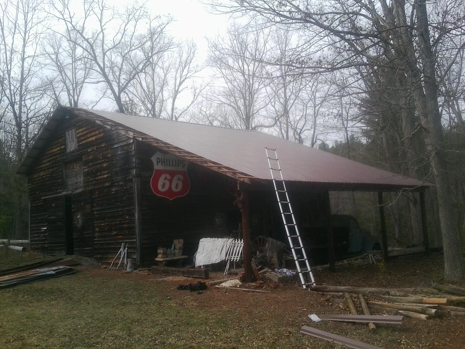 New metal roof on an open sided timber barn with a vintage sign in Carson